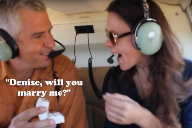 Man proposing to woman on helicopter flight. Text reads: Denise will you marry me?