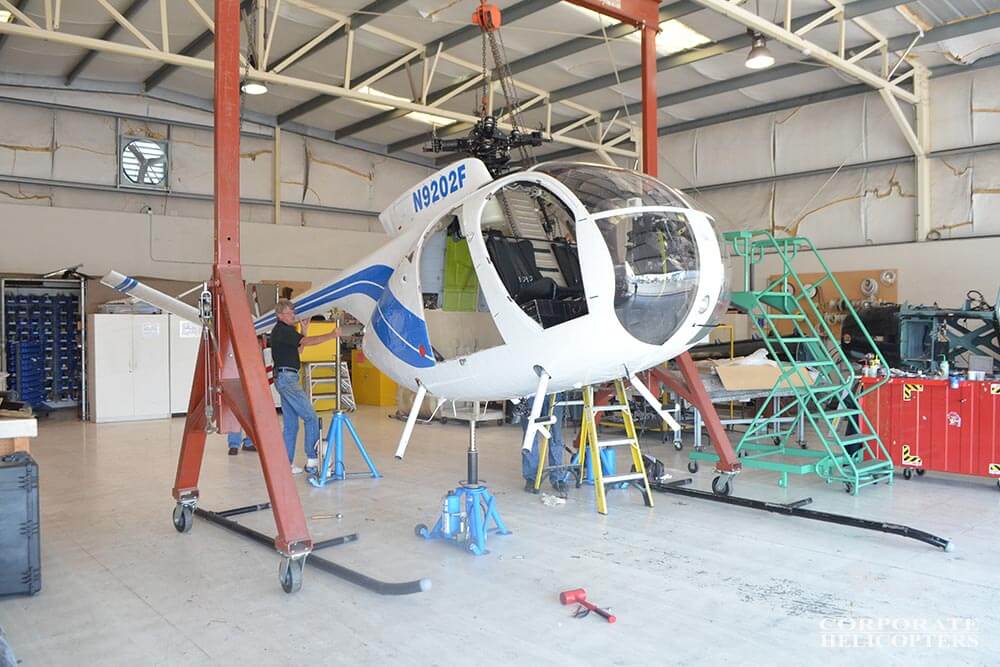 A MD500 helicopter being prepared for shipment