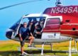 Men inside helicopter pose for the camera