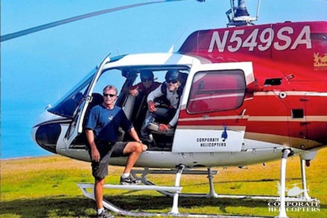 Men inside helicopter pose for the camera