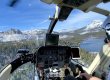 View from helicopter cockpit while flying over forrest and snowy mountains