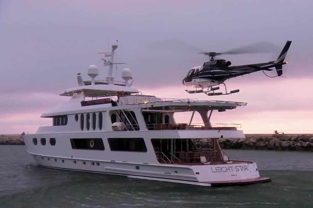 A helicopter lands on a yacht
