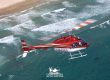 Helicopter flies above San Diego beach