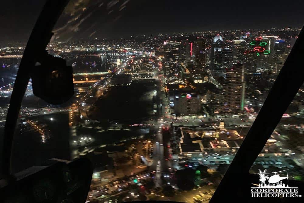Aerial shot of Downtown San Diego at night from helicopter interior.