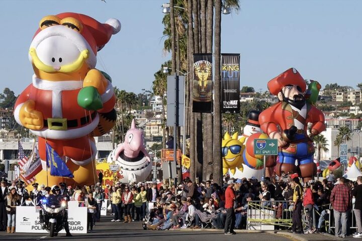 A parade, multiple large balloons are visible