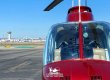 Helicopter landed at airfield with LAX in the background.
