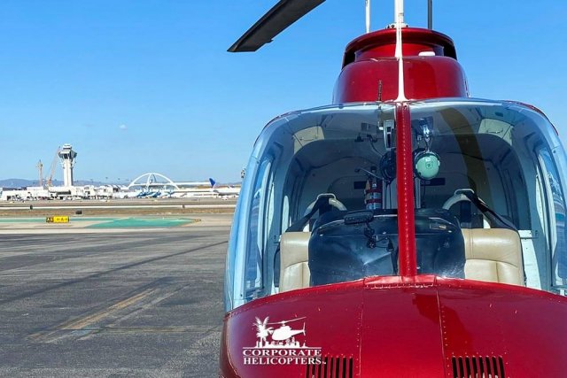 Helicopter landed at airfield with LAX in the background.