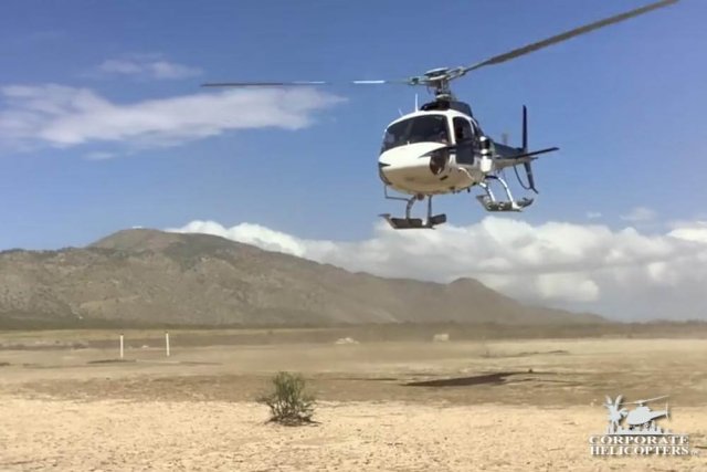 A helicopter landing in the desert