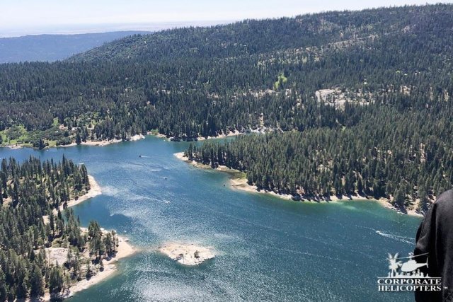 Aerial photo of mountain trees and a lake
