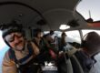 Skydivers prepare to jump out of a helicopter